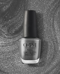 OPI nail polish bottle of Clean Slate nail lacquer standing upright, showcasing a sleek medium gray shade with a black cap against a swirling silver glitter background, highlighting the modern, neutral color for manicures and pedicures.