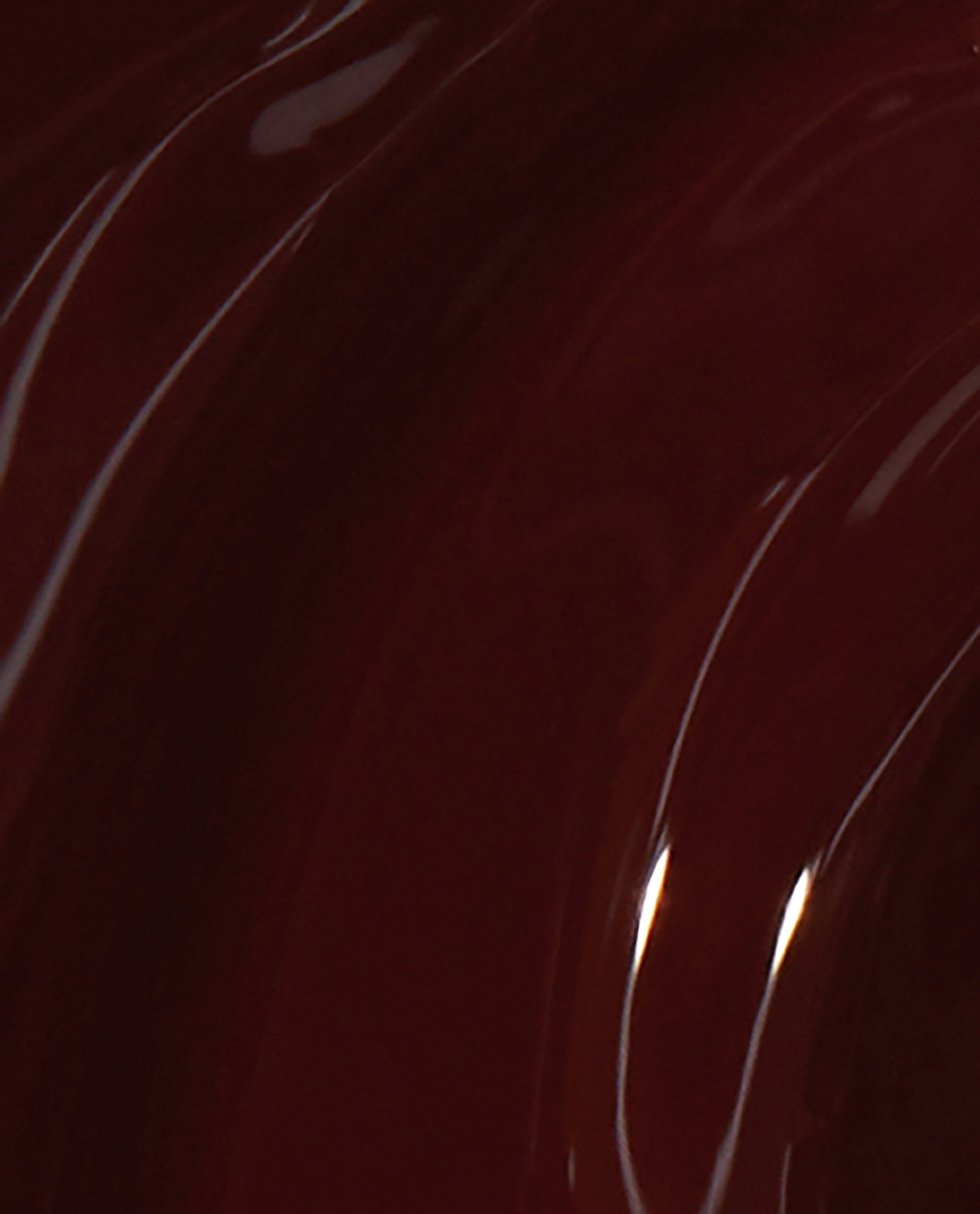Deep burgundy Complimentary Wine nail lacquer swirled in glossy curves, showing the rich, opaque finish and shine of this OPI nail polish shade in a close-up brush swatch.