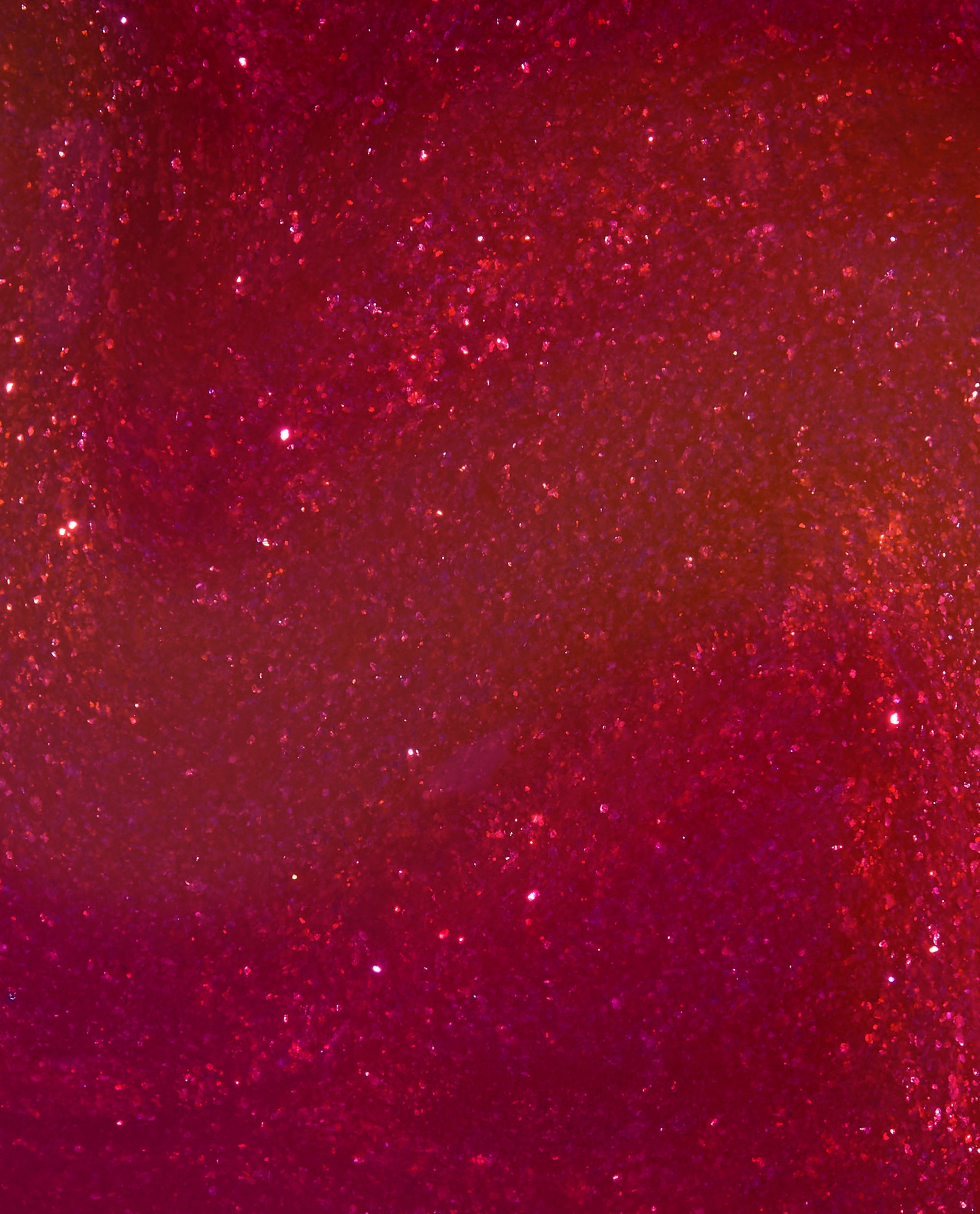 Deer Valley Spice OPI Infinite Shine nail polish swatch showing a deep berry-red shimmer with sparkling pink and copper flecks, a rich choice for fall nail colors.