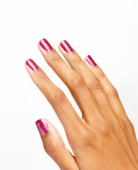 Hand with neatly manicured nails showcasing DeJa RoUgE Infinite Shine OPI nail polish, a glossy metallic berry-pink shade, displayed against a clean white background for a modern beauty product closeup.
