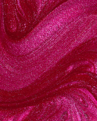 DeJa RoUgE Infinite Shine OPI nail polish swatch swirling in close-up, showing rich ruby-red color with intense pink shimmer and metallic sparkle across smooth, glossy liquid texture.