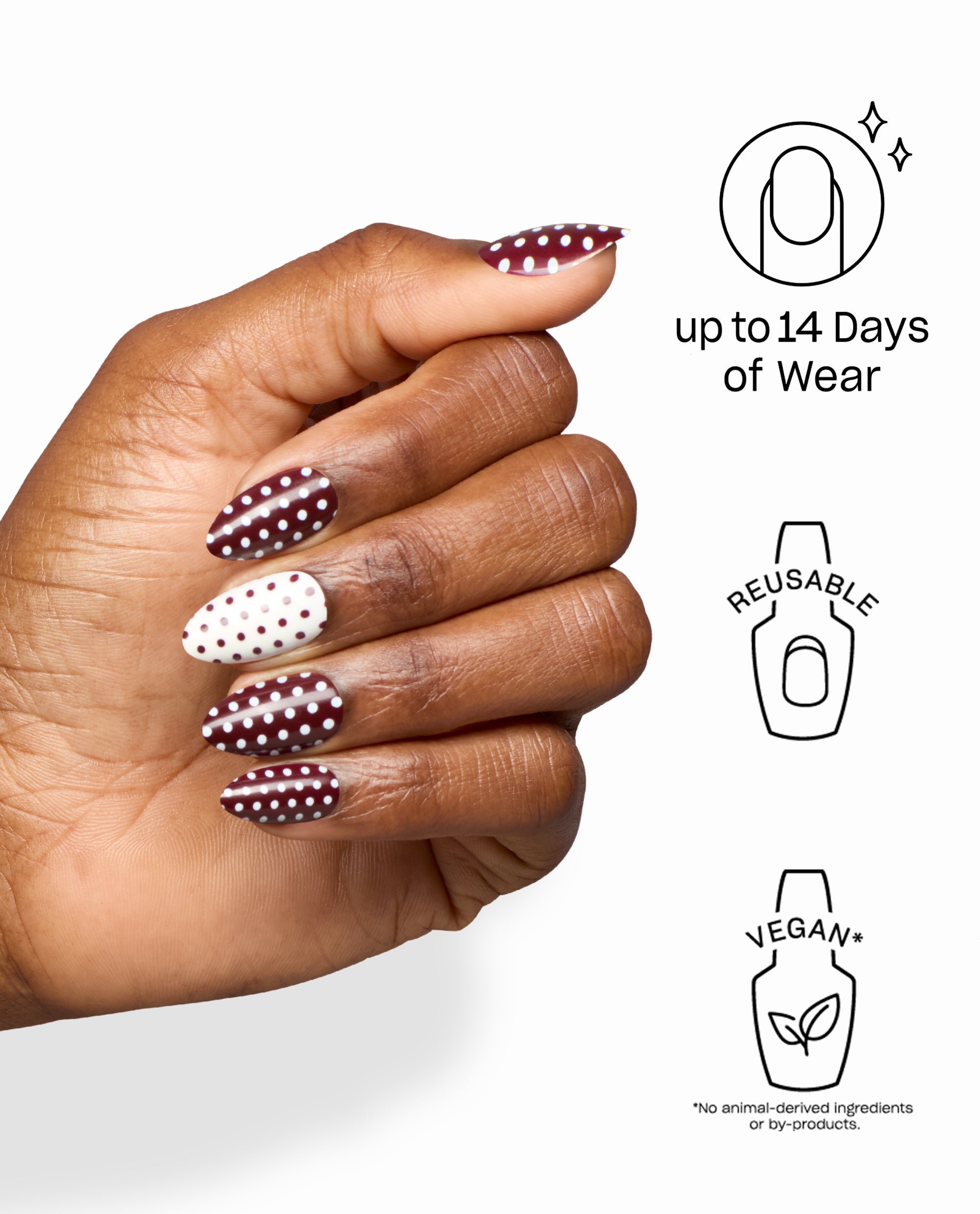 Dotticure On Point artificial nails worn on a hand, featuring burgundy and white polka dot almond tips inspired by OPI fall nail colors, with icons noting up to 14 days of wear, reusable, and vegan.