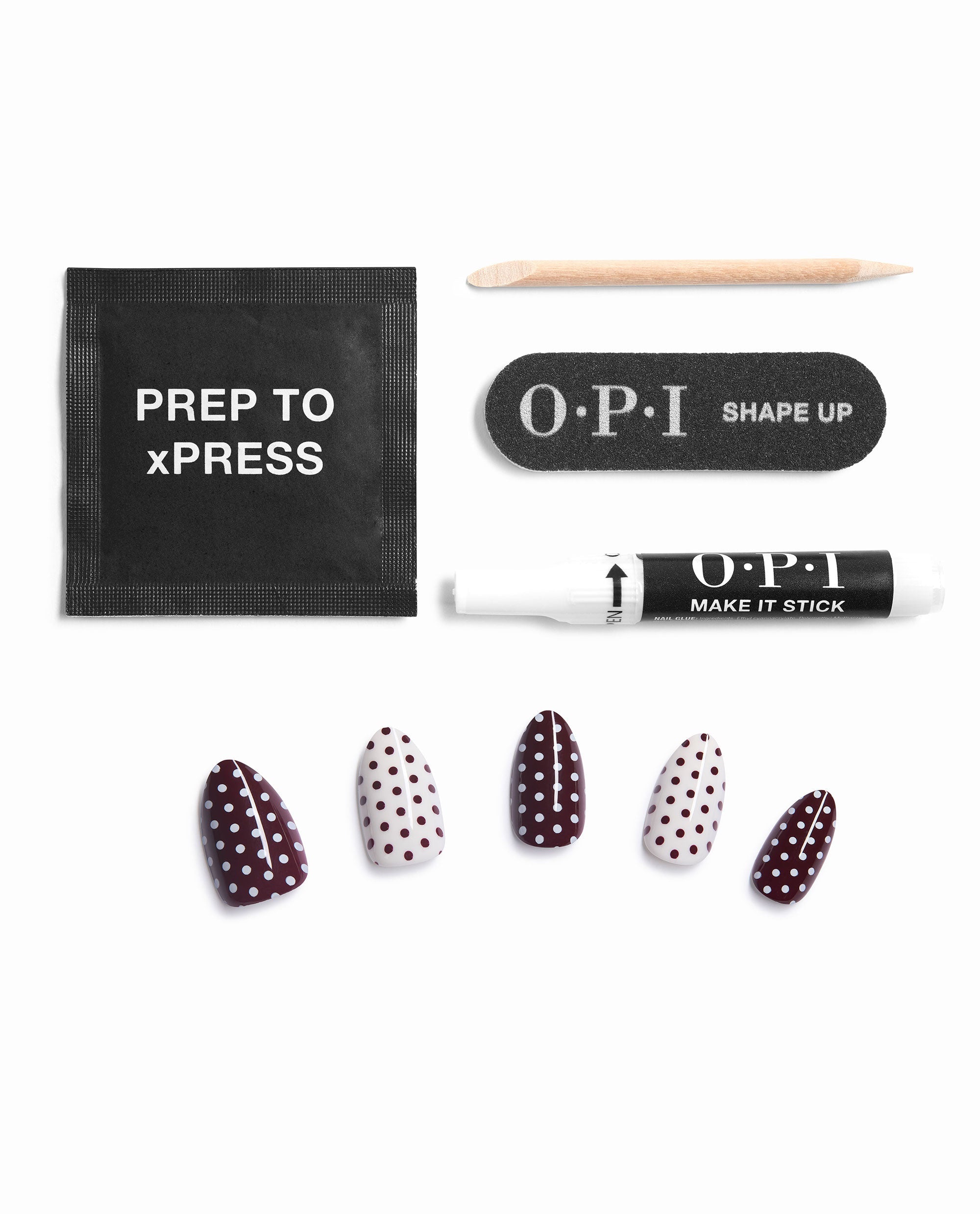 OPI Dotticure On Point press-on nail kit displays burgundy and cream polka dot fall nail colors with prep pad, wooden cuticle stick, OPI Shape Up file, and Make It Stick nail glue on a white background.