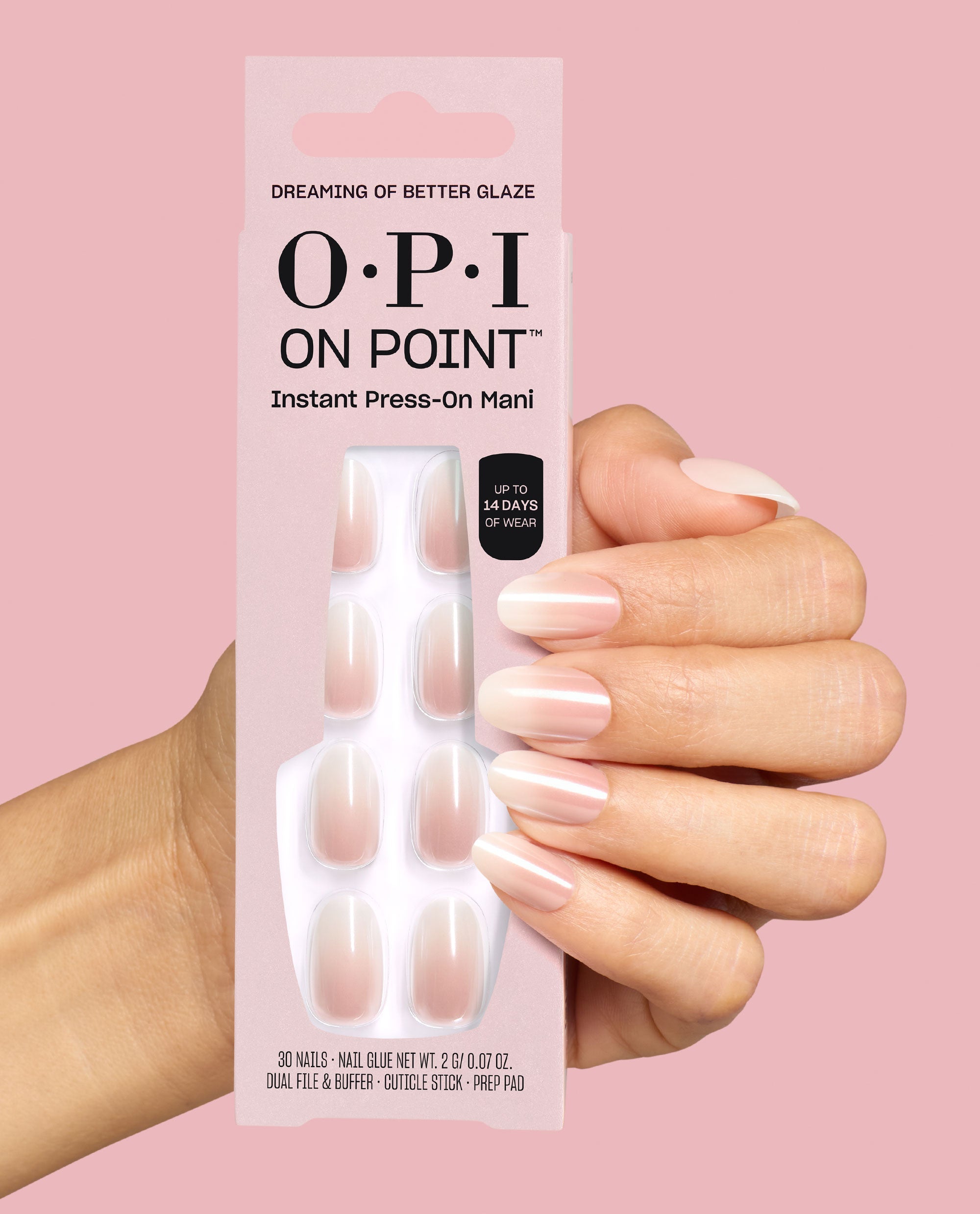 Hand holds OPI On Point Dreaming of Better Glaze instant press-on mani box, showing sheer pale pink glazed nails on a pink background, a soft option for fall nail colors.