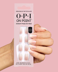 Hand holds OPI On Point Dreaming of Better Glaze instant press-on mani box, showing sheer pale pink glazed nails on a pink background, a soft option for fall nail colors.