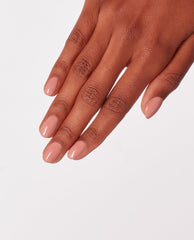 Hand with neatly manicured nails painted in Edinburgh-er & Tatties OPI nail polish, a glossy warm peachy nude nail lacquer, shown against a clean white background to highlight the smooth, even coverage and natural everyday shade.