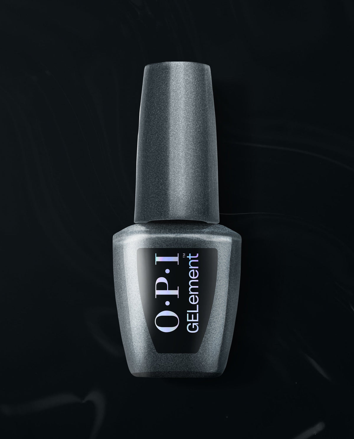 OPI EMOtional at-home gel nail polish bottle in metallic charcoal shimmer stands upright on a black satin background, a trending shade for salon-style manicures at home.