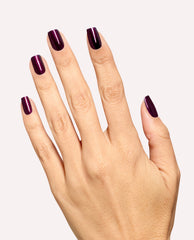 Hand modeling glossy deep plum burgundy nails using Every Month is Oktoberfest dipping powder by OPI, a rich shade for fall nail colors on a clean white background.