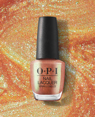 OPI nail polish bottle of #Virgoals nail lacquer standing upright, showcasing a shimmery peach-gold metallic shade against a swirling glittery orange backdrop, highlighting the sparkly, high-shine manicure color.