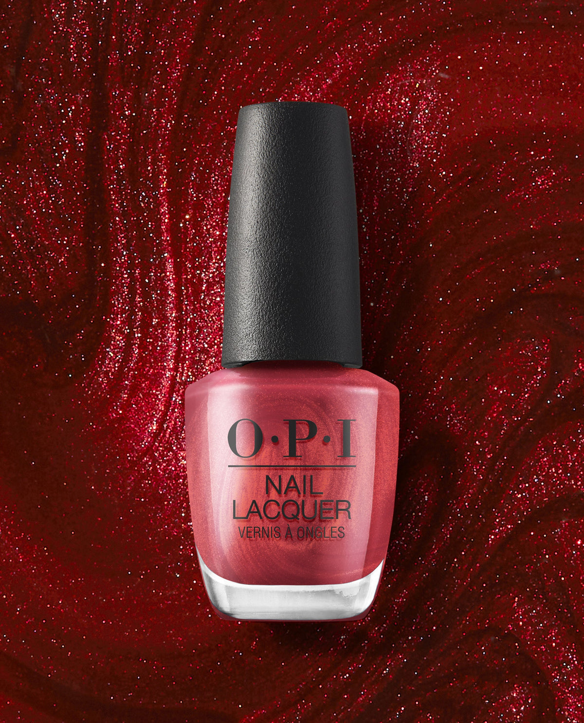 OPI nail polish bottle of CD Rom-antic nail lacquer standing upright, showcasing its shimmery metallic red shade against a swirling, glittery deep red background for a bold, glamorous manicure look.