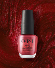 OPI nail polish bottle of CD Rom-antic nail lacquer standing upright, showcasing its shimmery metallic red shade against a swirling, glittery deep red background for a bold, glamorous manicure look.