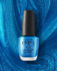 OPI nail polish bottle in Y2Slay nail lacquer, a vibrant shimmery electric blue shade, standing upright against a swirling glittery blue background that highlights the bold, high-gloss color for manicures and pedicures.