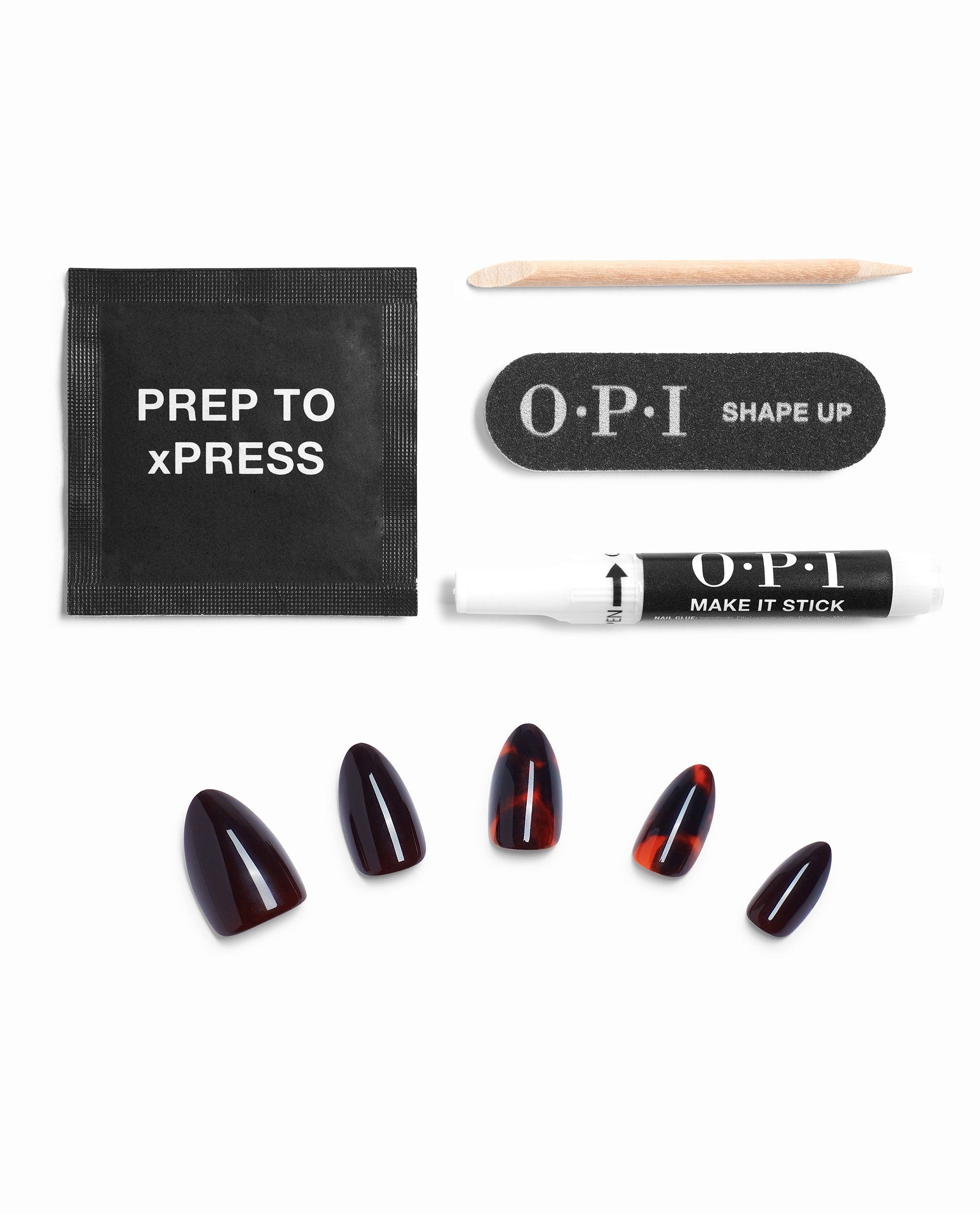 OPI This Turtle Bytes xPRESS/ON press-on nails in dark tortoise fall nail colors arranged with prep pad, wooden cuticle stick, nail file, and Make It Stick glue on a white background.
