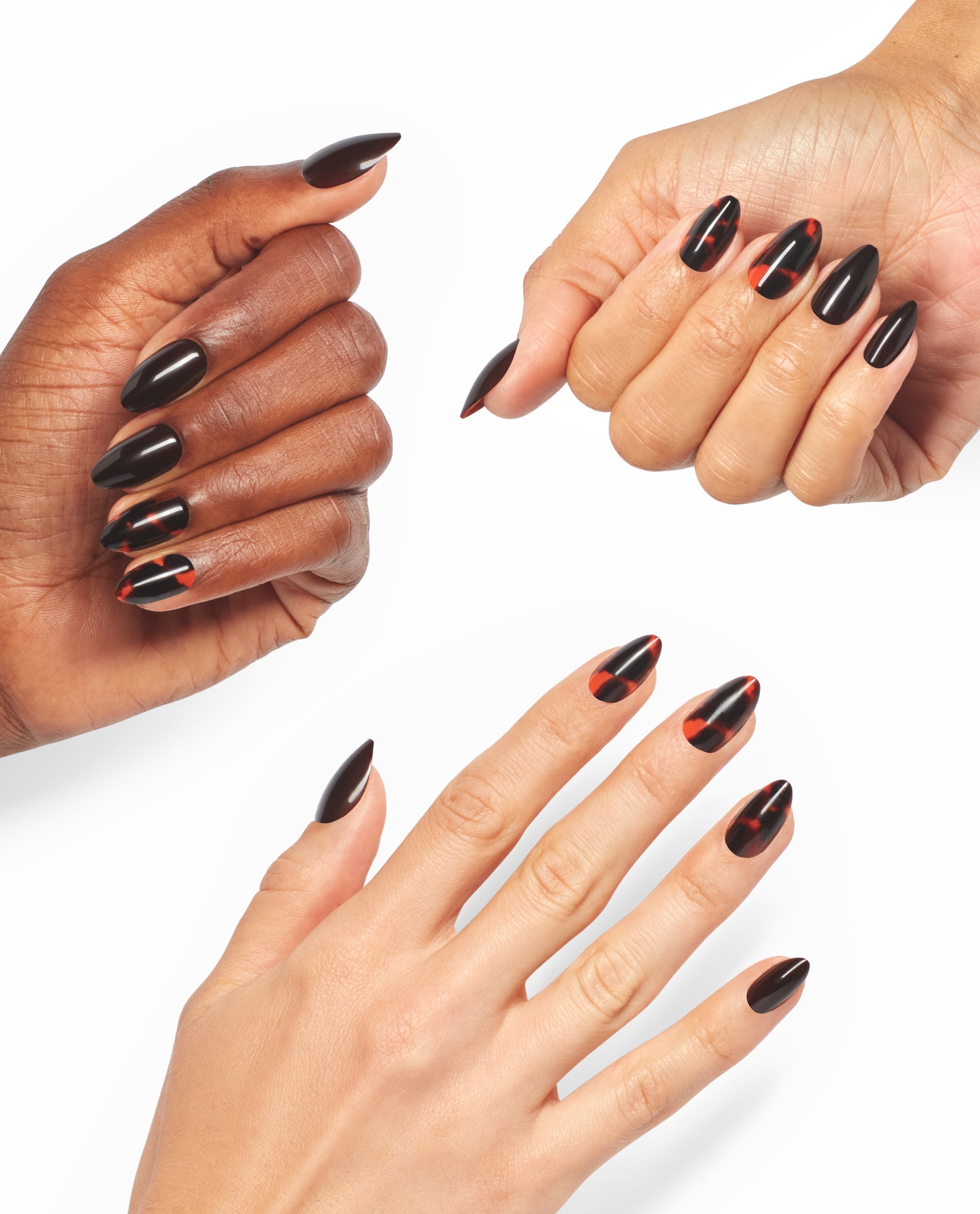 Hands model OPI This Turtle Bytes xPRESS/ON almond press-on nails in glossy black with red tortoiseshell accents, showcasing bold fall nail colors on a white background.