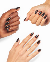 Hands model OPI This Turtle Bytes xPRESS/ON almond press-on nails in glossy black with red tortoiseshell accents, showcasing bold fall nail colors on a white background.