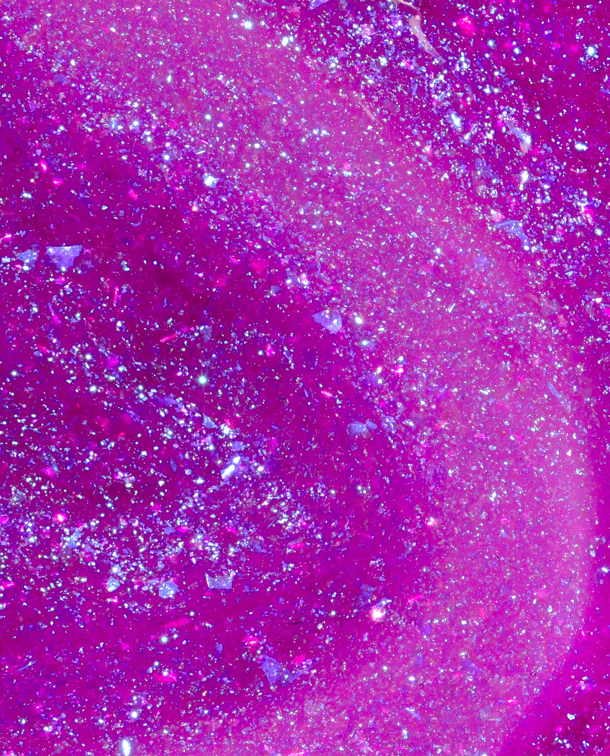Feelin’ Libra-ted OPI nail polish swatch showing bright fuchsia nail lacquer packed with fine holographic glitter and iridescent flakes swirling together in a dense, sparkling finish against a close-up studio background.