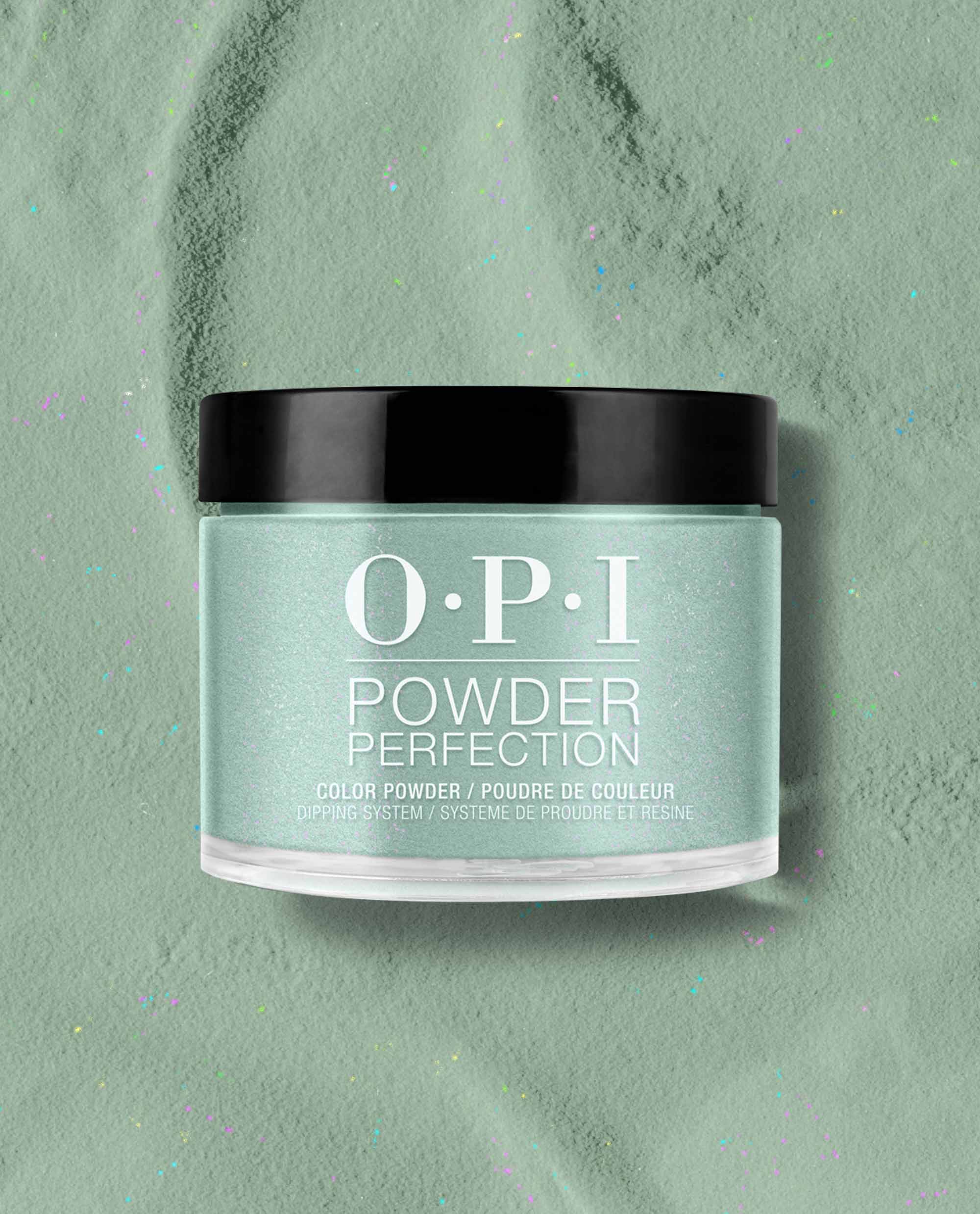 OPI Powder Perfection Feelin’ Capricorn-y dipping powder jar showcases a pastel mint green nail polish shade with fine shimmer, set on a matching powder surface with subtle confetti specks—fresh pick for spring nail colors from OPI.