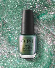OPI Feelin’ Capricorn-y Nail Lacquer bottle showcasing iridescent green nail polish with fine glitter, centered on a swirled sparkly emerald backdrop—a fresh, shimmery choice for spring nail colors from OPI.