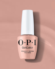 OPI GelColor France-y Seeing You Here gel nail polish in a soft peachy nude shade stands upright with a white cap on a blush pink background, ideal for subtle fall nail colors.