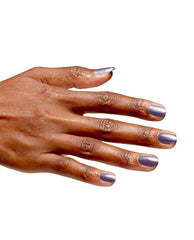 Hand with neatly manicured nails painted in Funmetal Infinite Shine, a metallic lavender-gray OPI nail polish, shown against a clean white background to highlight the smooth, glossy finish and full-coverage color.
