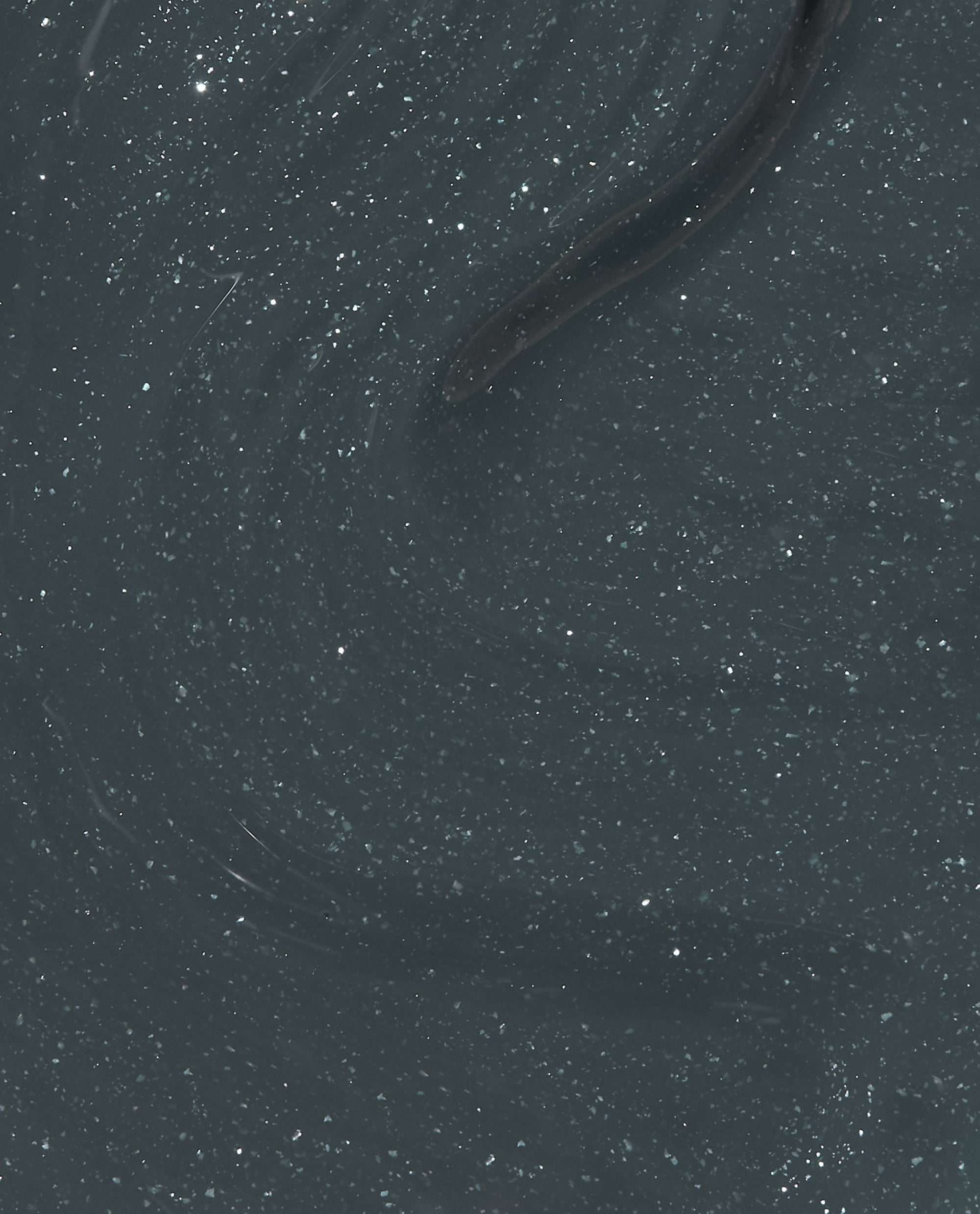 OPI nail polish Get in Platform-ation Infinite Shine shown as a close-up swatch of deep charcoal gray lacquer with fine silver shimmer swirling through a glossy, gel-like finish, highlighting its rich, high-shine coverage for manicures and pedicures.
