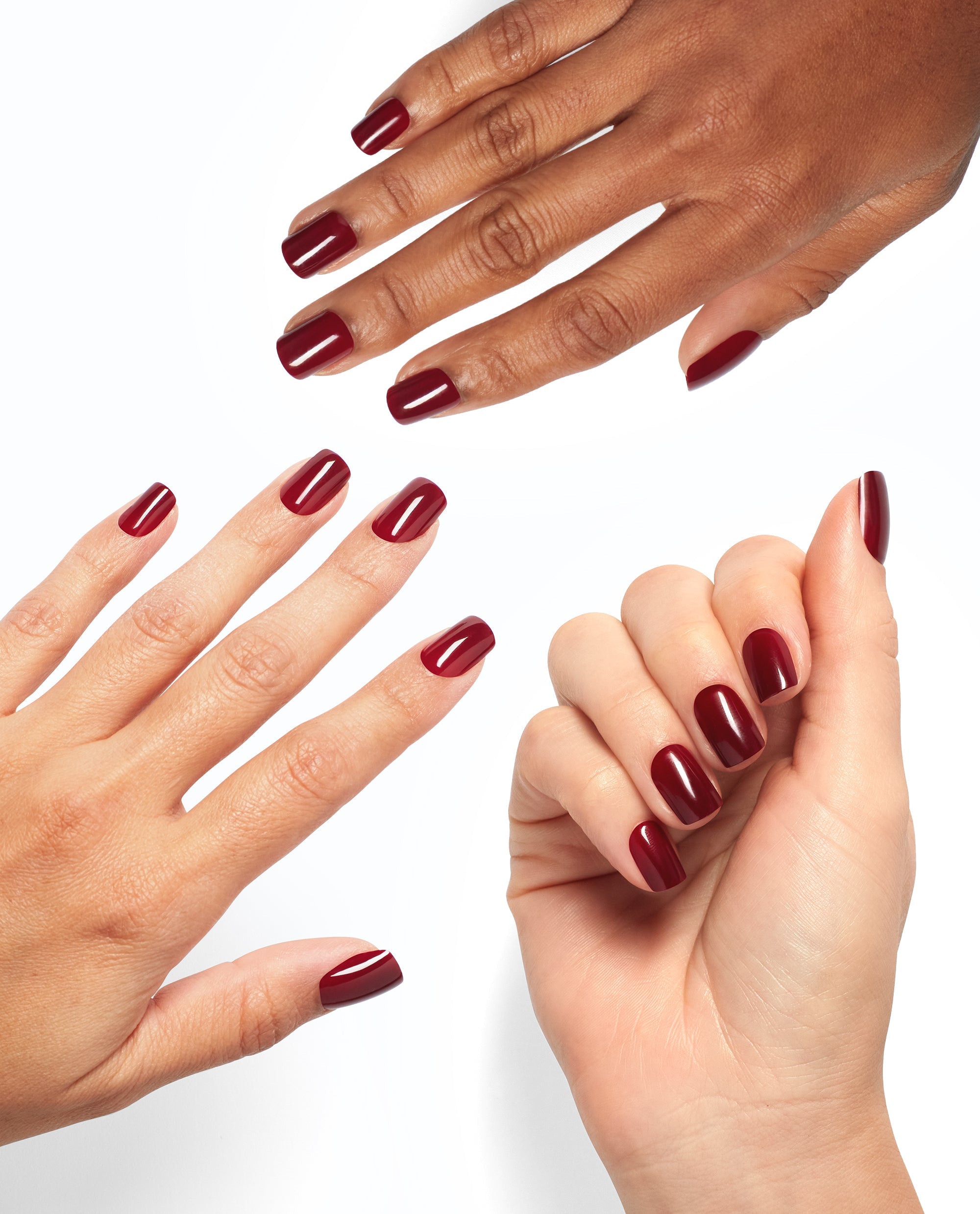 Hands modeling glossy deep burgundy Got the Blues for Red On Point nails, showcasing an OPI-inspired shade among classic fall nail colors on a clean white background.