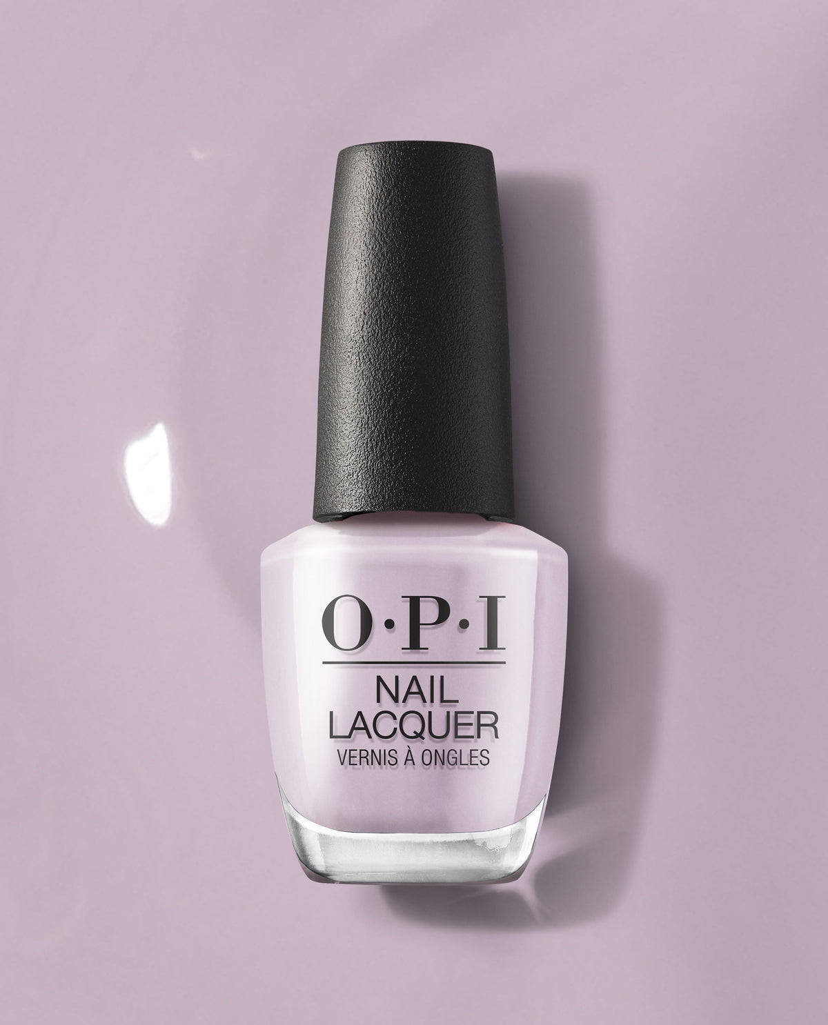 OPI nail polish bottle in the Graffiti Sweetie shade standing upright, showcasing pale lavender nail lacquer with a black cap against a matching soft purple background, highlighting the glossy pastel color for manicures and pedicures.