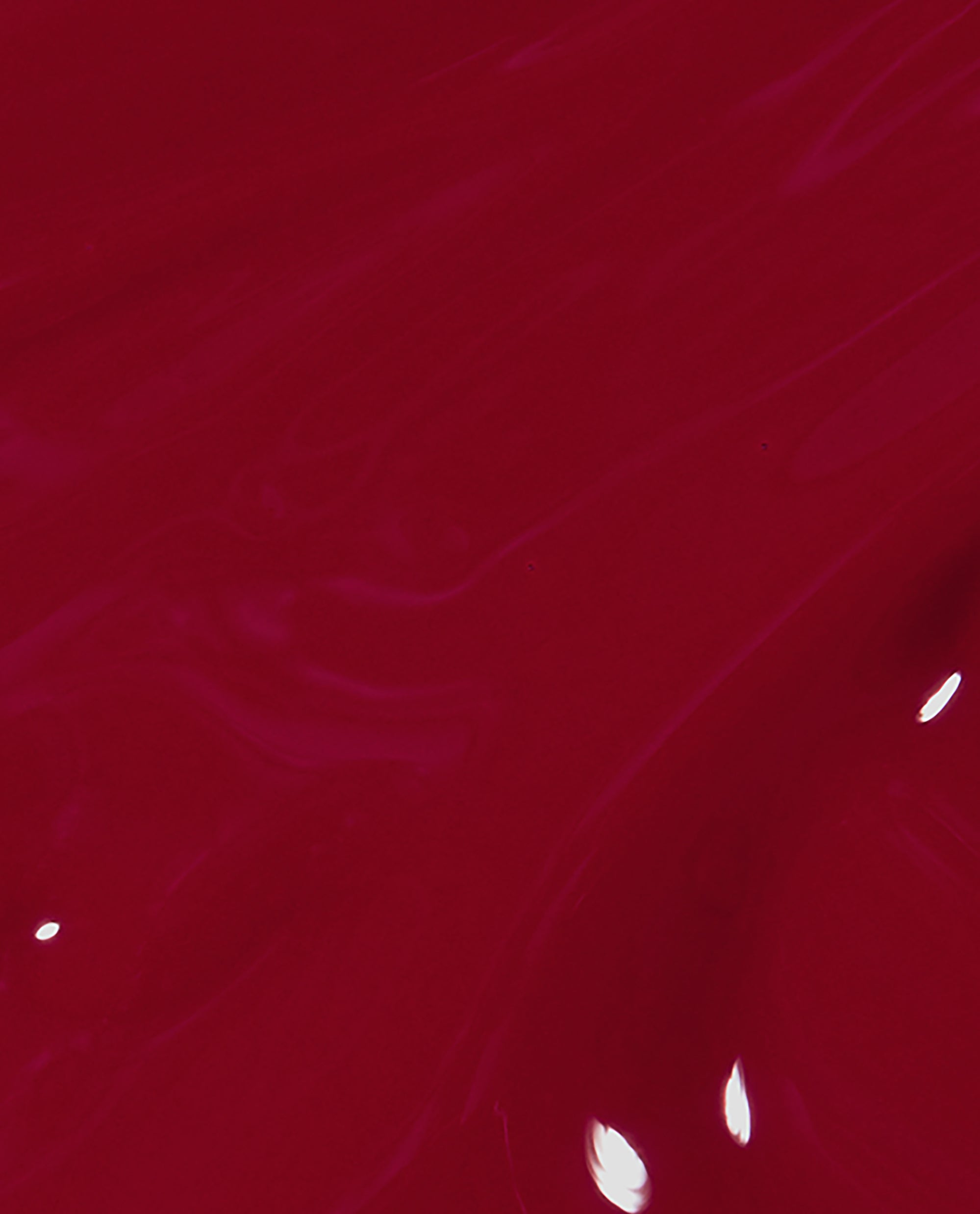 Glossy brush swatch of OPI nail polish shade I Love You Just Be-Cusco, showing rich, deep raspberry-red nail lacquer with subtle streaks and highlights against a smooth, fluid background.