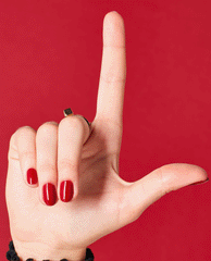 Hand with short, glossy red nails painted in OPI nail polish shade I Love You Just Be-Cusco held in an L shape against a matching red background, showcasing the vibrant nail lacquer color and smooth, even coverage.