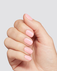 OPI I’m the Gloss! at-home gel nail polish creates a trending glossy soft pink manicure on short oval nails against a light gray studio background.