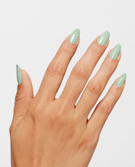 Almond-shaped nails painted with OPI In Mint Condition Infinite Shine, a glossy pastel green nail polish, shown on a hand against a white background highlighting fresh spring nail colors.