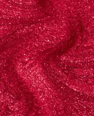 Kiss My Aries nail lacquer swirls in a close-up, showing rich ruby-red OPI nail polish with dense golden shimmer and glittery metallic finish, highlighting its bold, sparkly texture for vibrant manicures.