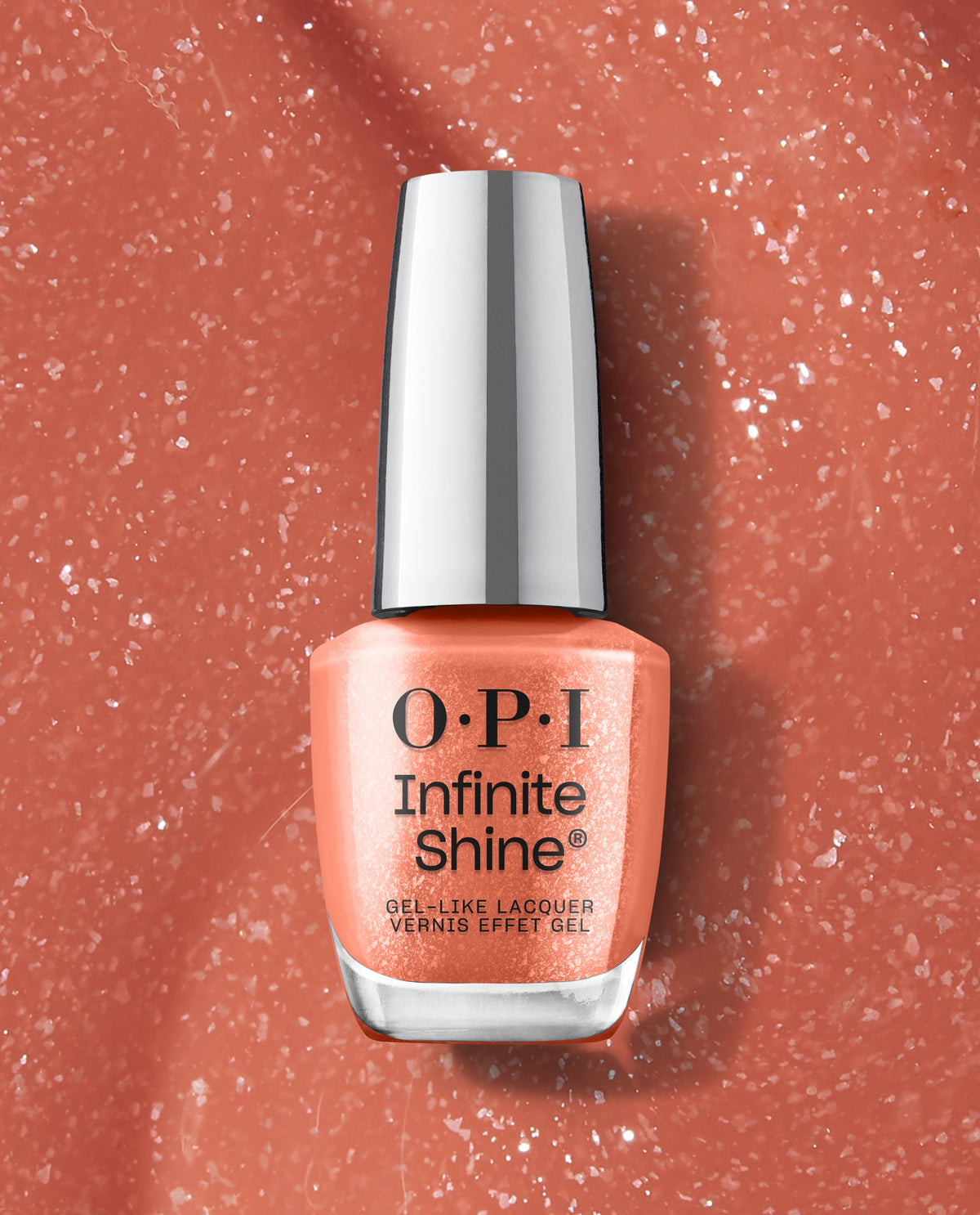 OPI nail polish bottle of Knee High Stock-blings Infinite Shine, a shimmery coral gel-like lacquer, standing upright against a close-up textured coral glitter background for a bold, long-wear manicure look.
