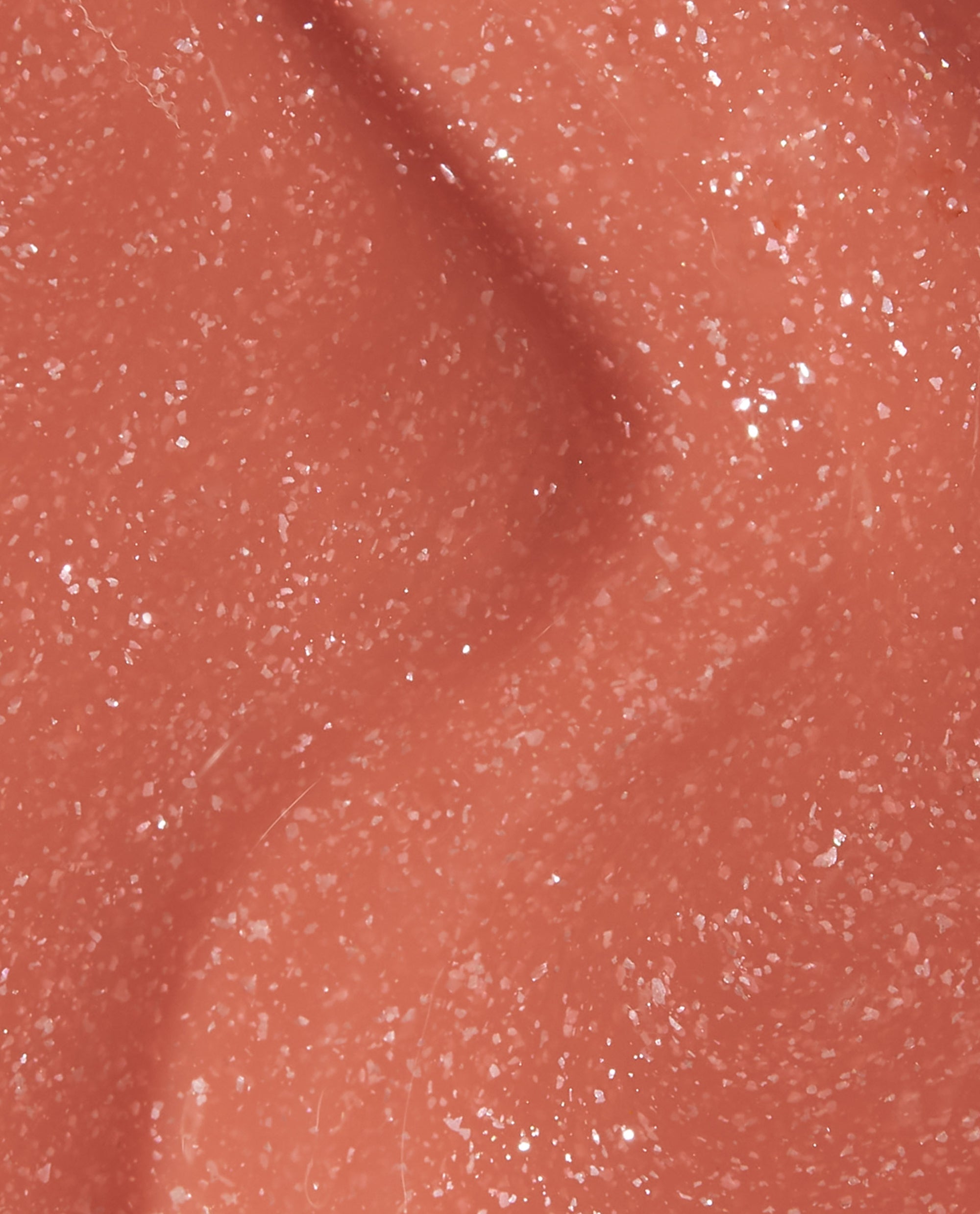 Close-up swatch of OPI nail polish Knee High Stock-blings Infinite Shine, showing a smooth coral-orange base packed with fine silver shimmer, flowing in soft curves to highlight its glossy, long-wear finish.