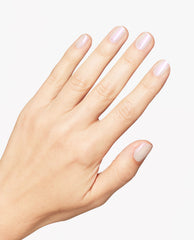 Hand displaying a glossy manicure with OPI Infinite Shine Kyoto Oyster, a sheer pearly white nail polish, on short rounded nails against a clean white background.