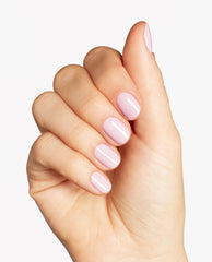 Fingernails display OPI Infinite Shine in Lavender Bath, a glossy pale lavender-pink polish, on a hand posed against a clean white studio background.
