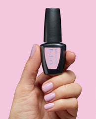 Hand with glossy lavender manicure holds OPI Let Me Lavender at-home gel nail polish bottle against a pink background, showcasing a soft shade for fall nail colors.