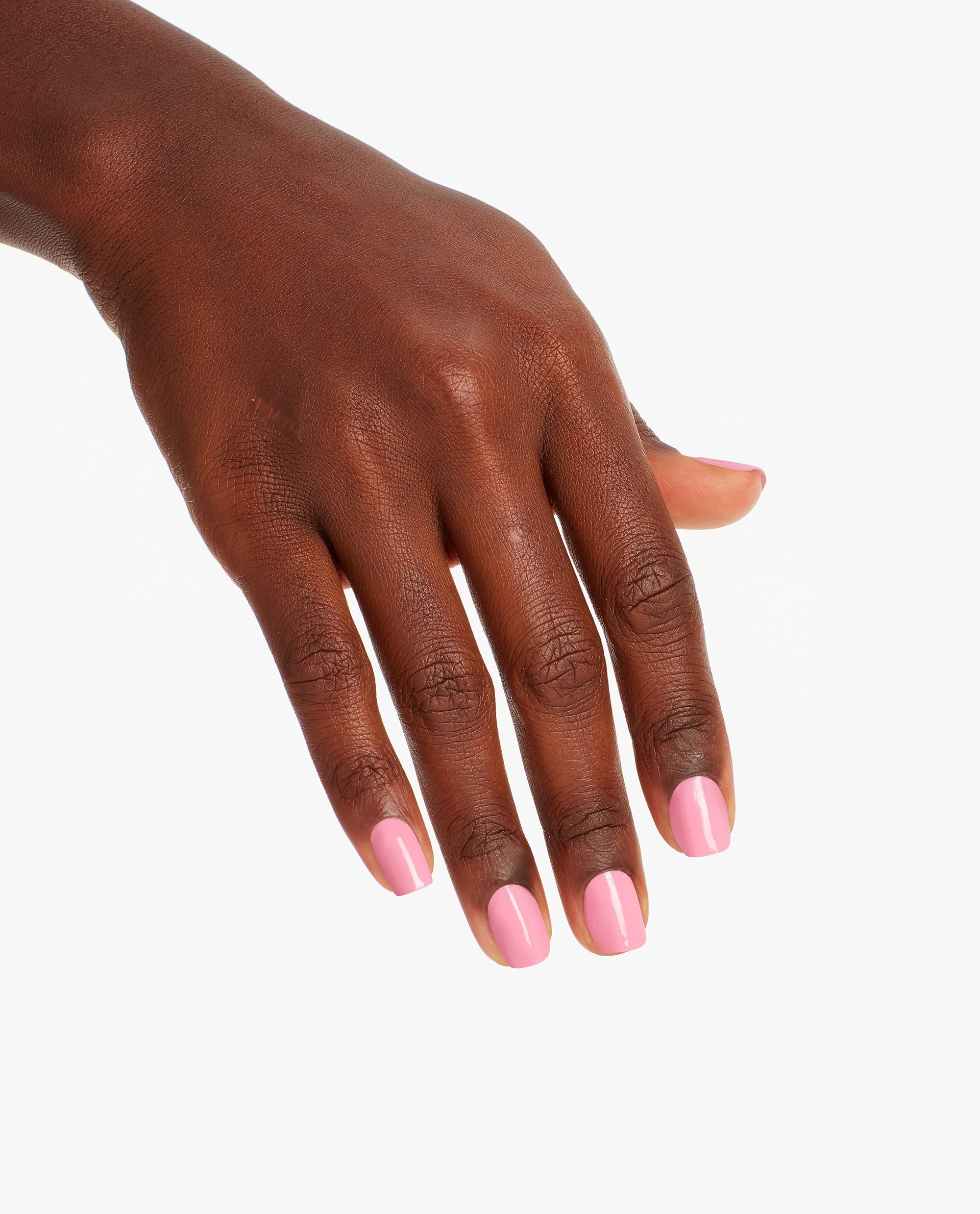Hand with neatly manicured nails showcases Lima Tell You About This Color! OPI nail polish, a glossy pastel pink nail lacquer, against a clean white background for a modern, salon-quality look.
