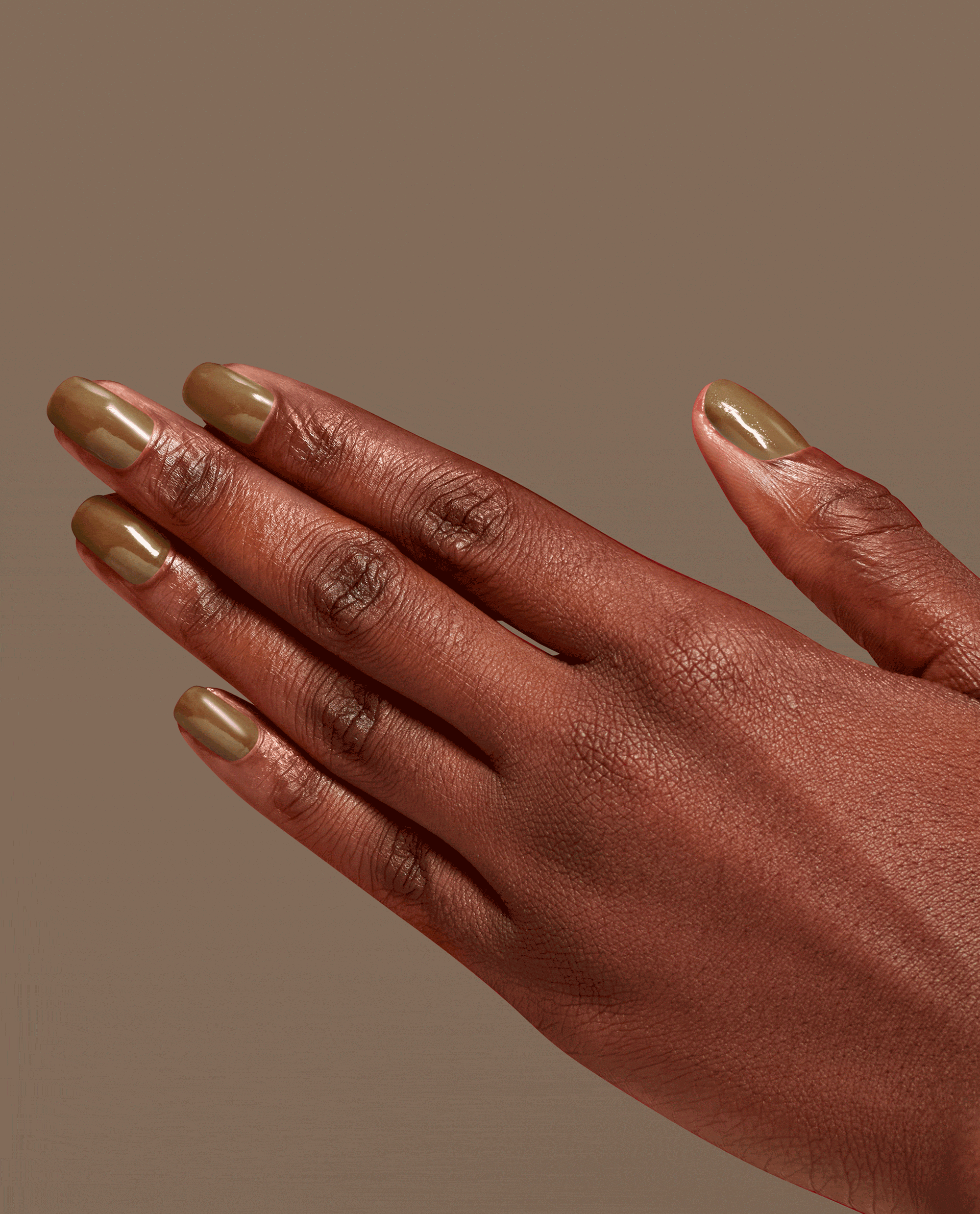 Hand modeling OPI Infinite Shine Livin' La Vida Mocha, a glossy warm mocha-brown nail polish on short rounded nails against a neutral taupe background.