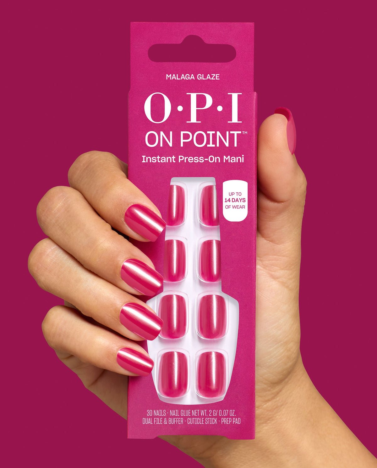Hand with glossy fuchsia nails holds OPI On Point Malaga Glaze Instant Press-On Mani pack with matching pink press-on nails, up to 14 days wear, against a magenta background for bold fall nail colors.