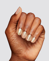 Hand shows short, neatly manicured nails painted with OPI MarshmelloOo So Sweet Infinite Shine, a soft pink nail polish gift set shade with fine iridescent shimmer against a clean light gray background.