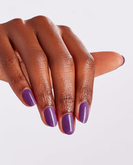 Hand with neatly manicured nails painted in Medi-take It All In, a glossy purple OPI nail polish nail lacquer, held against a clean white background to showcase the smooth, even color coverage.