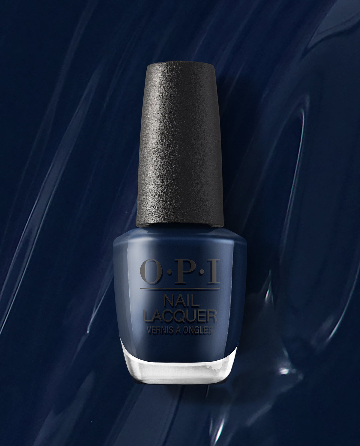 OPI nail polish bottle of Midnight Mantra nail lacquer standing upright, showcasing a rich, glossy midnight navy blue shade against a matching swirled blue background, highlighting the deep, salon-quality color for manicures and pedicures.
