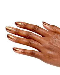 Hand modeling OPI Millennium Mocha nail lacquer, a metallic bronze-gold shimmer on almond-shaped nails, shown on a white background for fall nail colors inspiration.