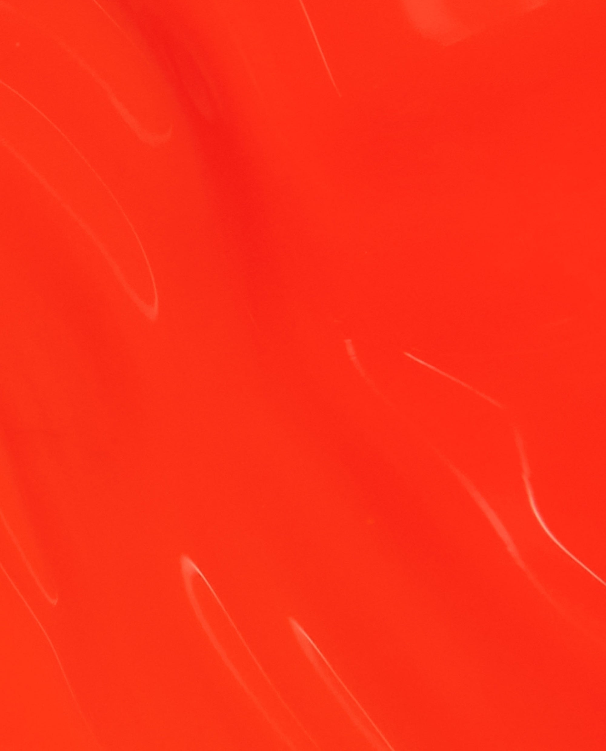 Glossy swatch of OPI nail polish in Mini Plaid Flirt Infinite Shine, showing a smooth, vibrant orange-red lacquer with subtle reflective streaks across the surface.