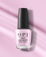 OPI Mod About Me nail lacquer bottle in soft pastel pink with a black textured cap, standing on a pink background with gentle shadows.