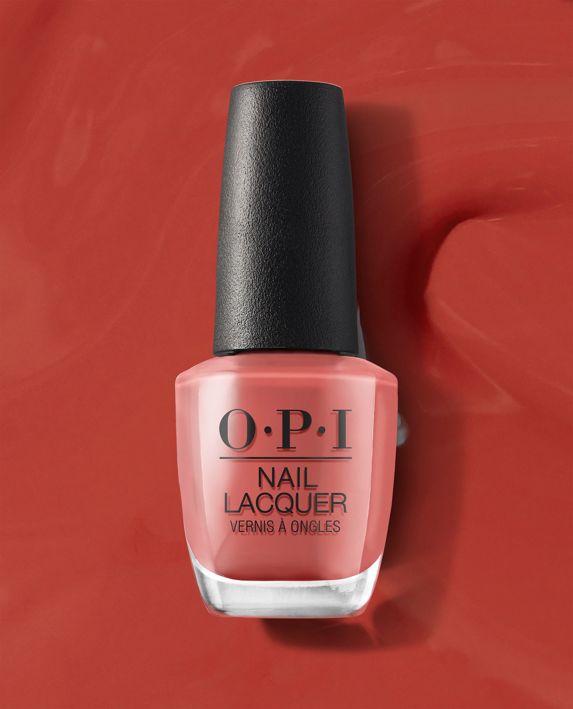 OPI nail polish bottle of My Solar Clock is Ticking coral nail lacquer standing upright on a matching glossy red-orange background, showcasing the shade’s warm, sunset-inspired color for manicures and pedicures.
