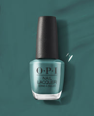 OPI nail polish bottle of My Studio's on Spring teal nail lacquer standing upright against a matching glossy teal background, showcasing the rich, creamy color and black textured cap for a modern salon-quality manicure look.
