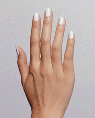 Hand displays a glossy white manicure using OPI Nail Envy Alpine Snow Nail Strengthener, a trending nail treatment, against a soft gray studio background.