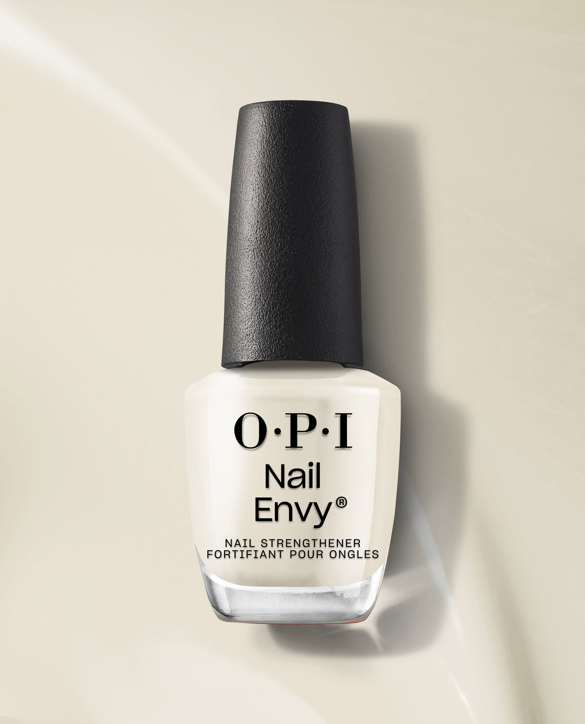 OPI Nail Envy Nail Strengthener bottle standing upright on a glossy beige surface, showcasing the clear treatment formula and black textured cap, ideal as a nail polish gift set or daily nail care treatment for stronger, healthier nails.